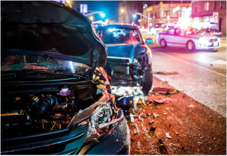 Two cars in a night time accident.