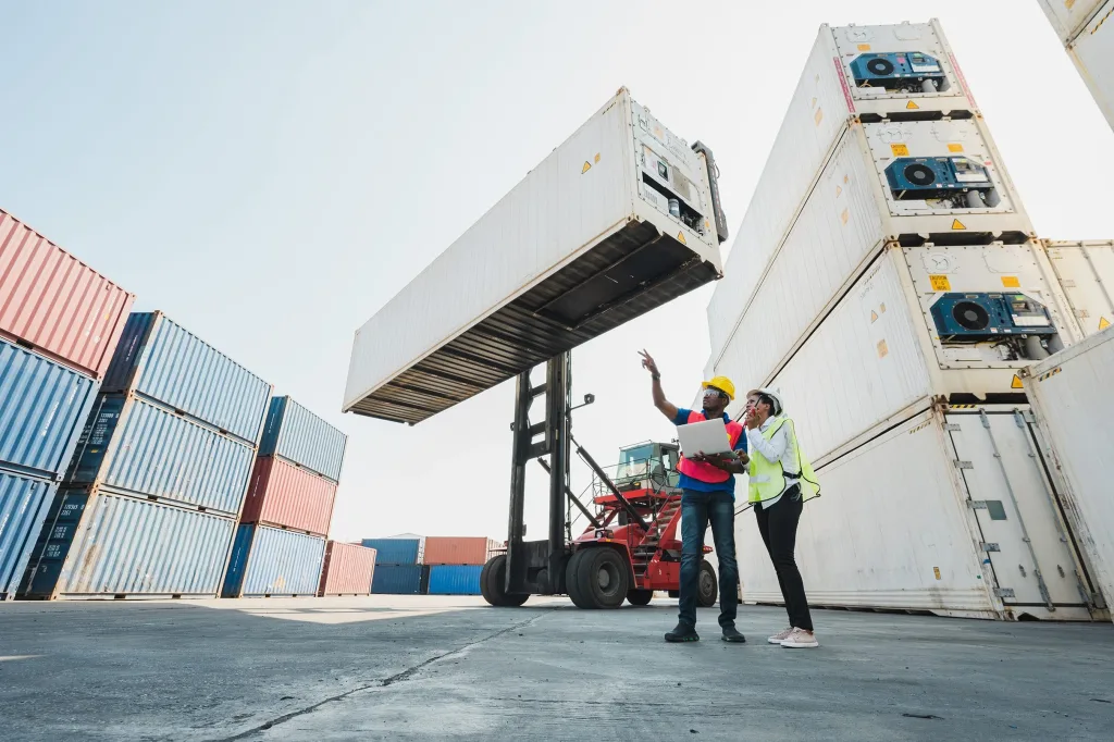 Maritime workers standing on a ship surrounded by shipping containers. If you’ve been injured as a maritime worker, our Houston maritime lawyers are ready to fight for you.