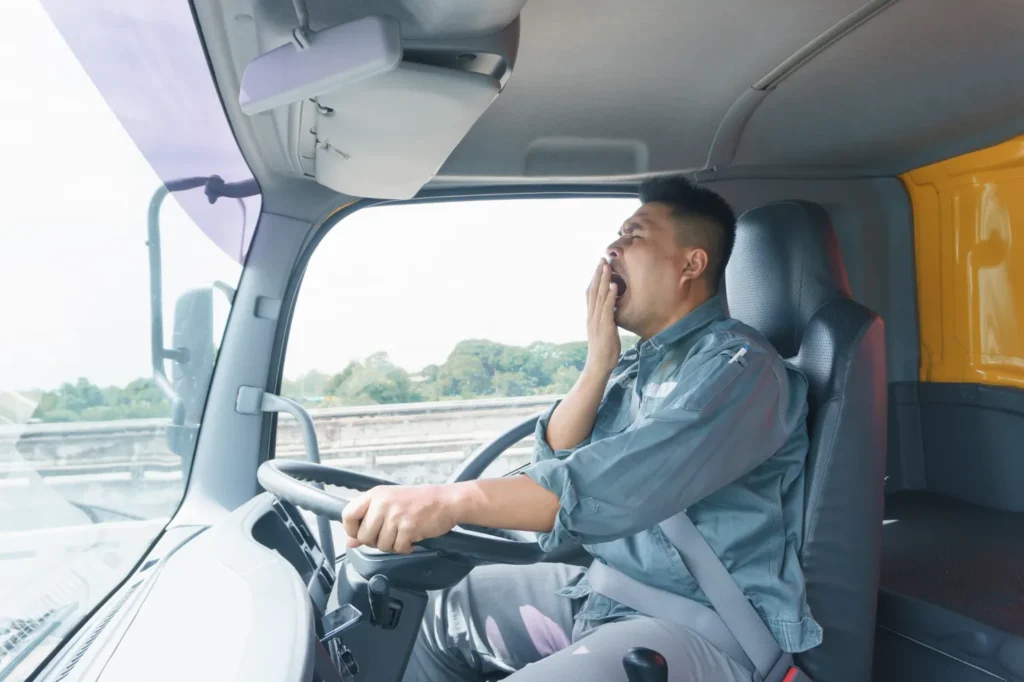 A driver yawning behind the wheel.