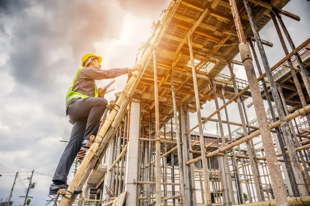 A construction worker climbing a ladder.